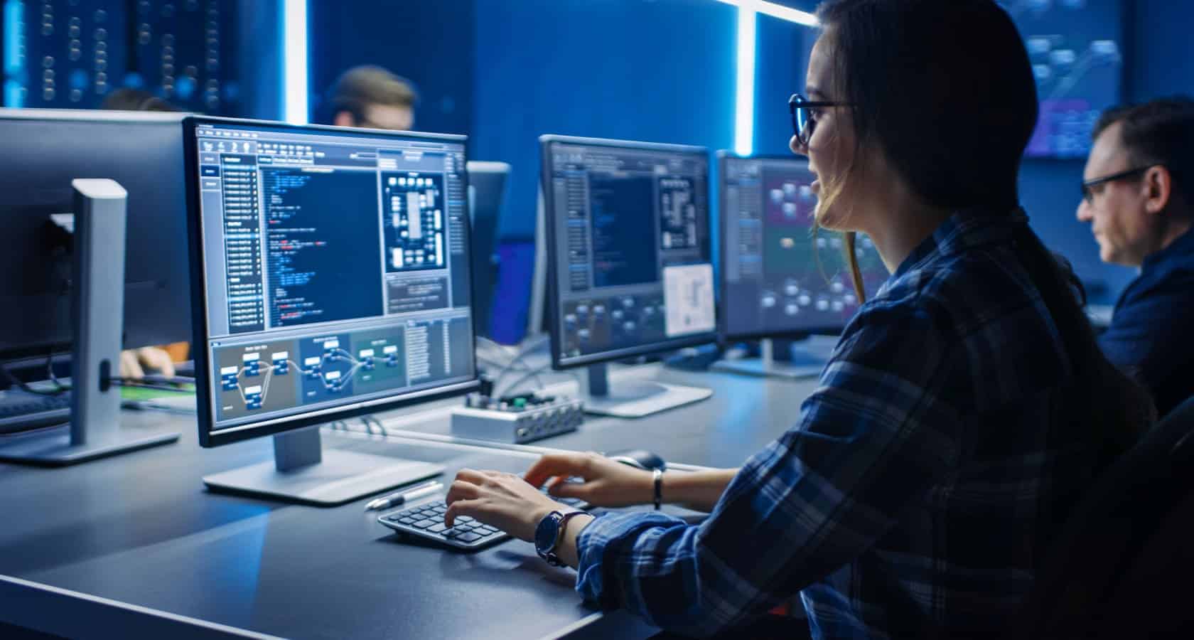 programmer at a computer in an open plan office